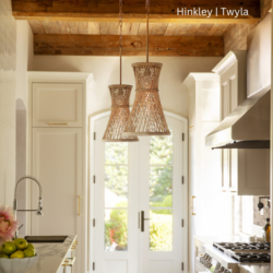 Narrow kitchen with a wood ceiling that has two oblong pendant lights hanging from it.
