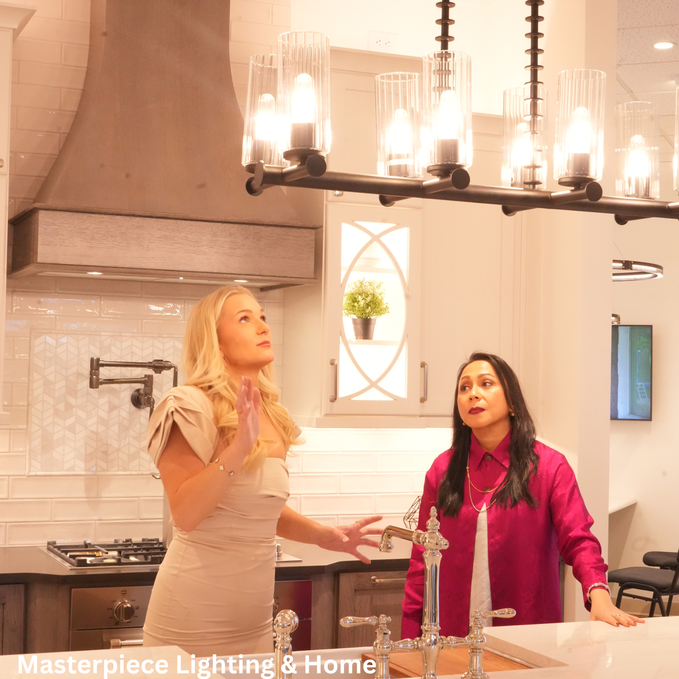 Two women discussing the benefits of a light fixture in a showroom.