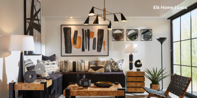 Living room that features a variety of light sources including a chandelier and lamps.