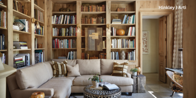 Living room with bookshelves on the walls and a focus on wall sconces.