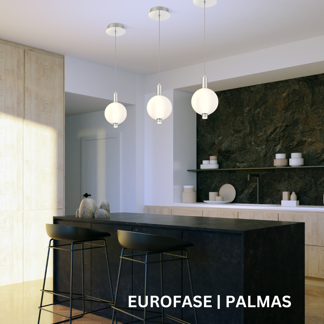 Three white spherical pendant lights hanging over a black kitchen island.