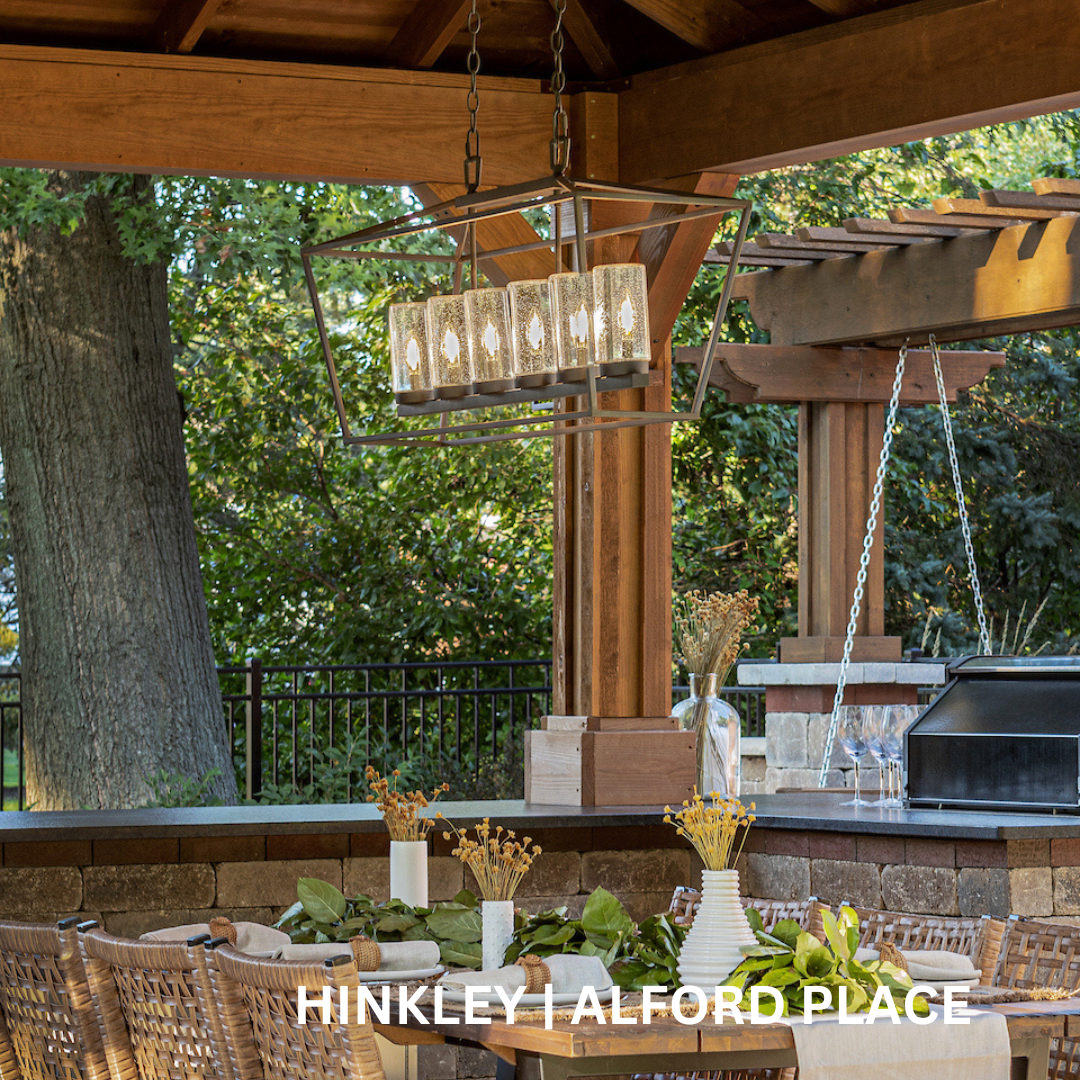 Outdoor dining area with a 6 light metal chandelier.