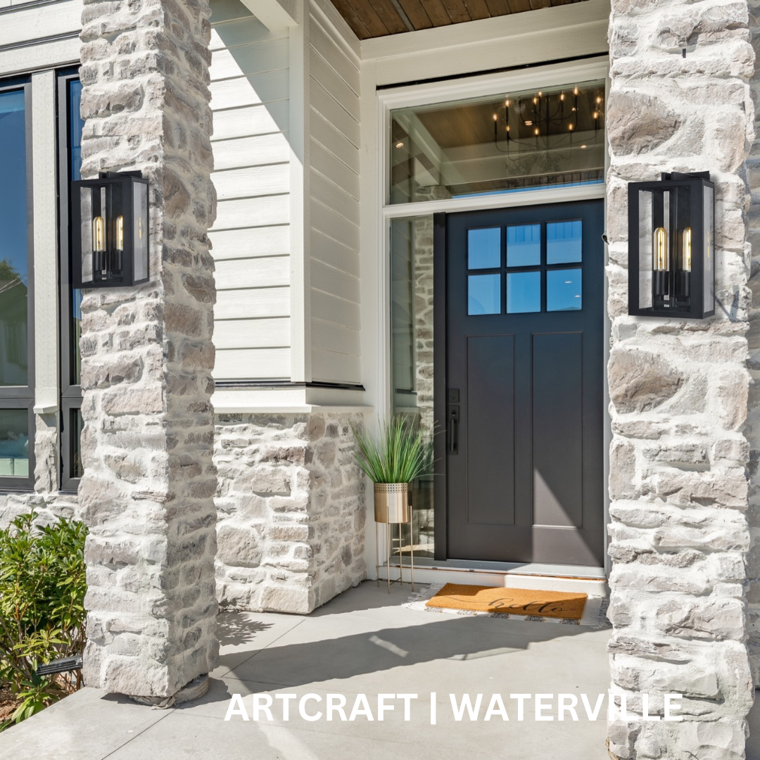 Two black wall sconces on brick columns along either side of an entryway.