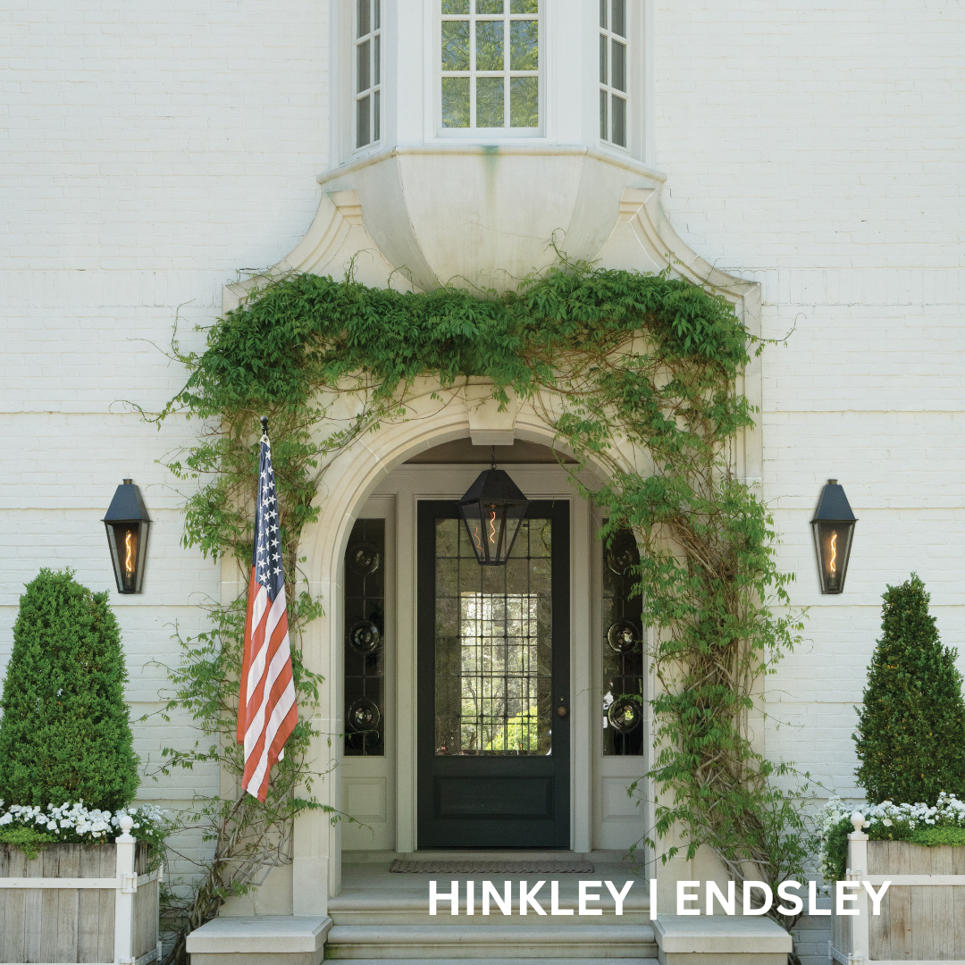 Front entryway with three lanterns. One above the door and two on either side of the entryway.