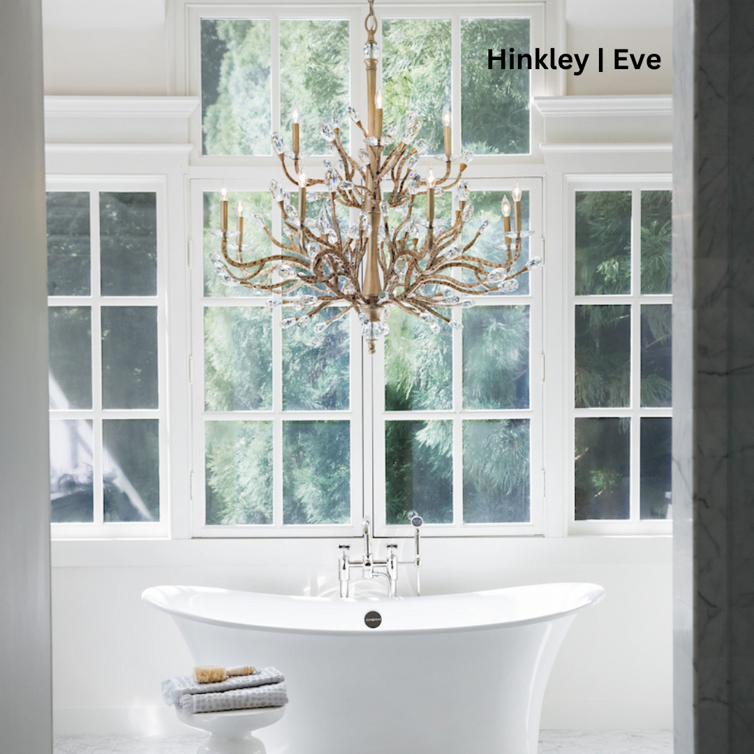 Golden chandelier with vine-like tubing tipped with crystal hanging over a bathtub.