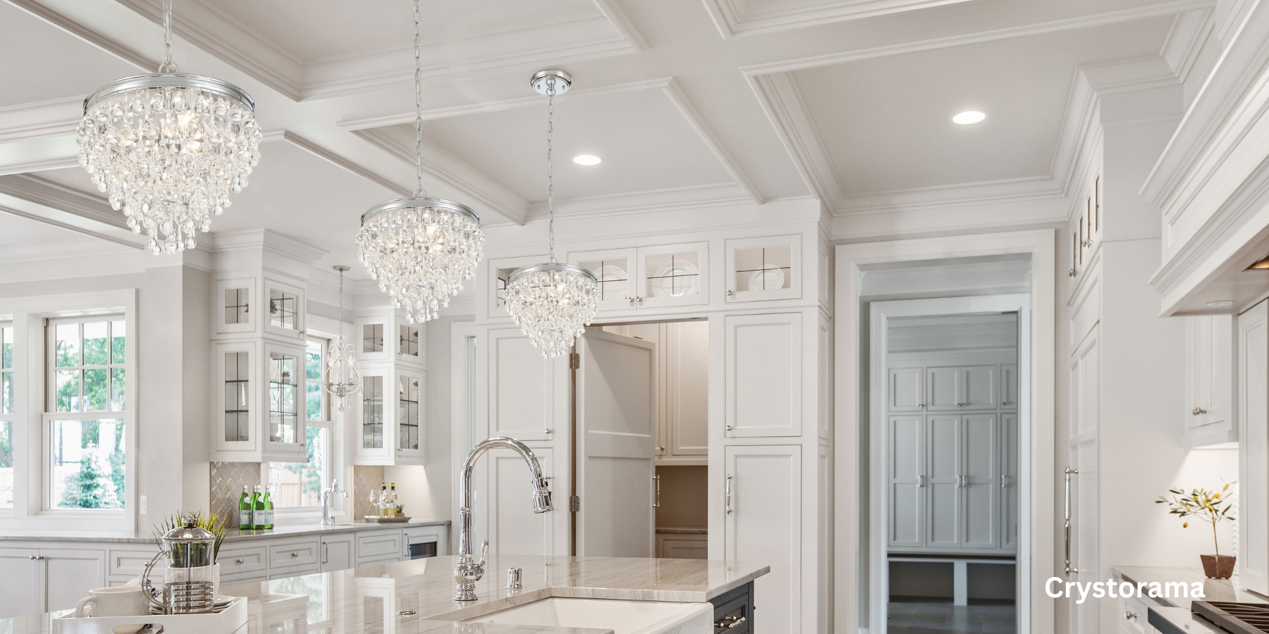 Crystal chandleries hanging in a white kitchen.
