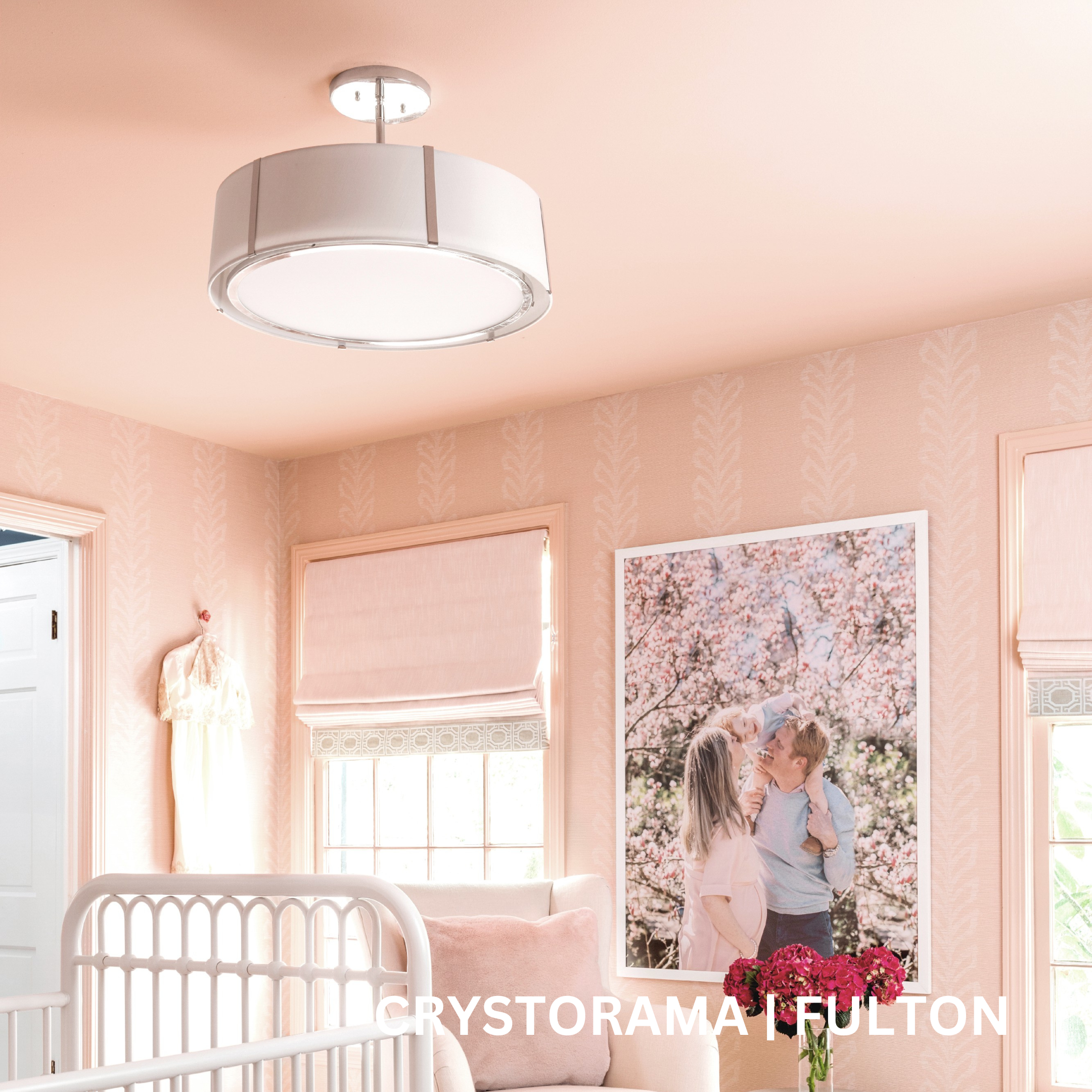 Pendant fixture made from a white fabric shade with silver accents.